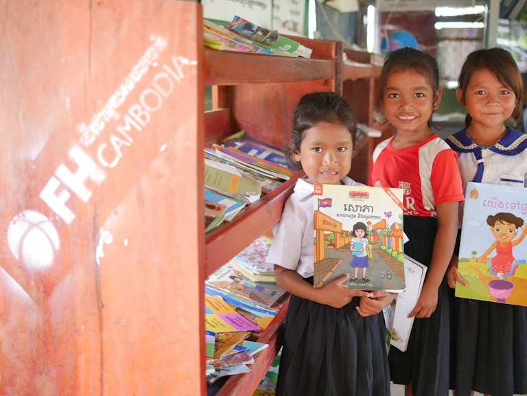 Children in Cambodia enjoying new literacy resources thanks to donors.