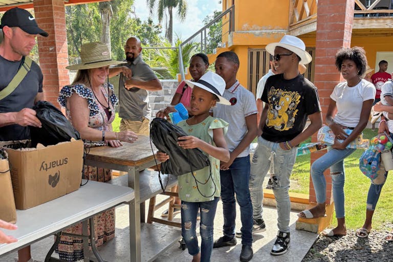 Mortgage Movement team members hand out 2,000 educational packs to children in the Dominican Republic.
